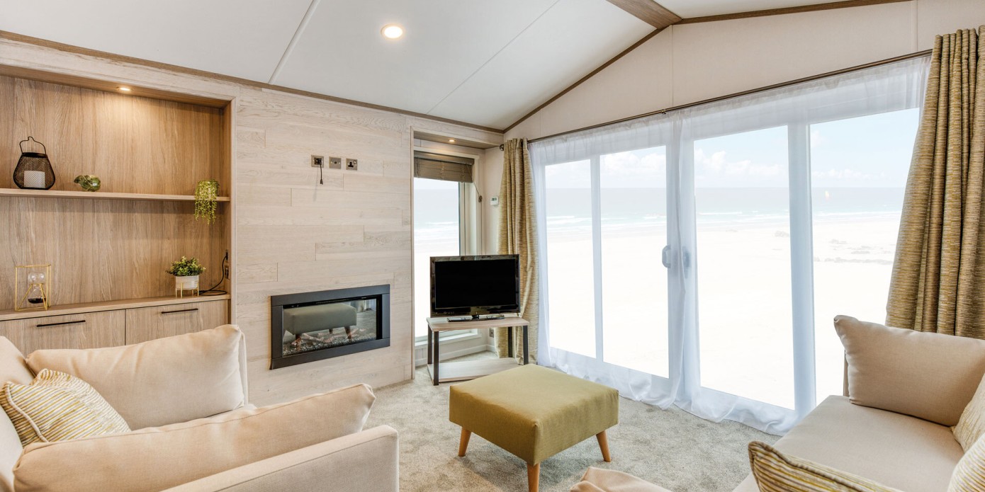 lounge with patio doors in the 2025 Atlas Jasmine Lodge