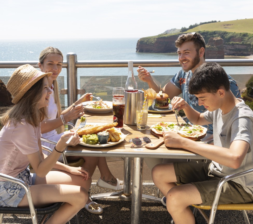 Eating outside by the sea at Ladram Bay Holiday Park