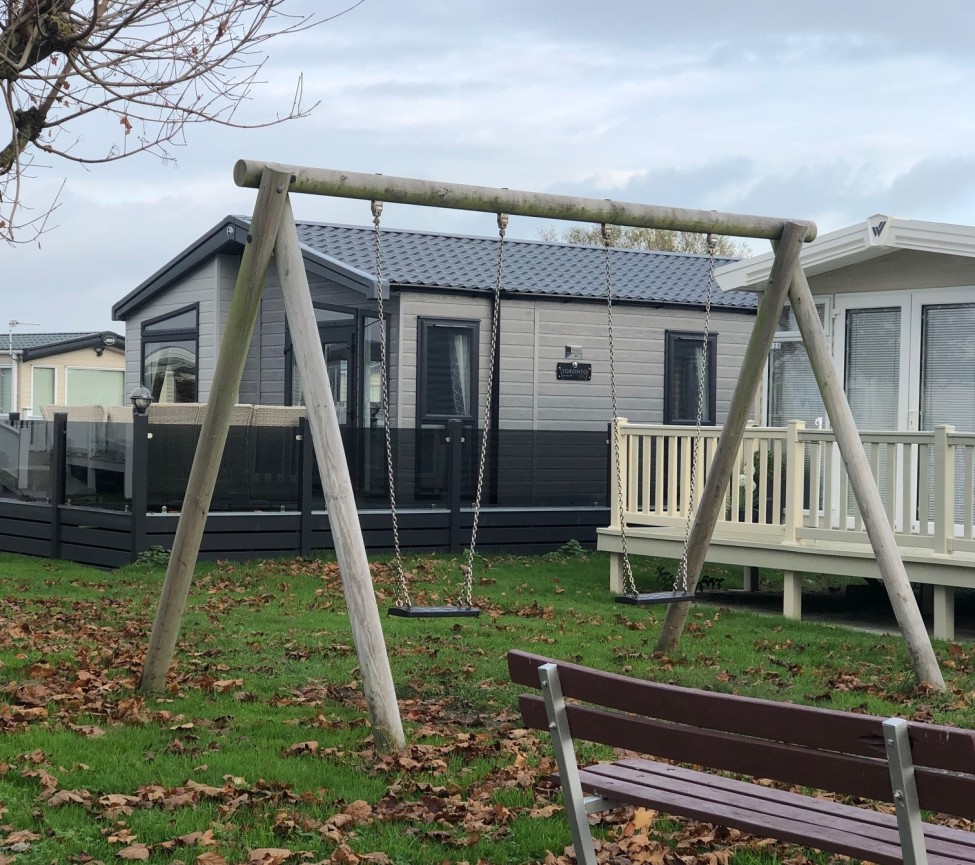 swings by the caravans at Sandy Glade Holiday Park