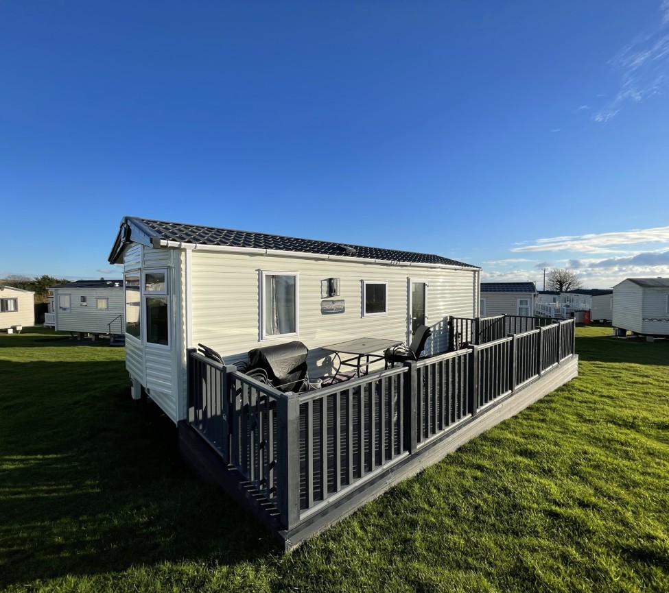 West Wayland Caravan Park with caravans and decking area for sale