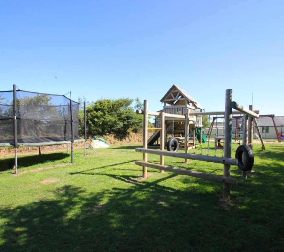 outdoor play area with trampoline on the park