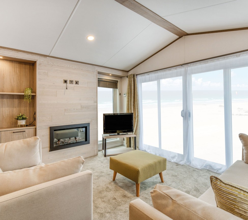 lounge with patio doors in the 2025 Atlas Jasmine Lodge